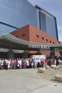 Photo caption: Stamford Health staff and volunteers join President and CEO Brian G. Grissler to cut the ribbon outside of the emergency department and celebrate the official opening of the new Stamford Hospital.